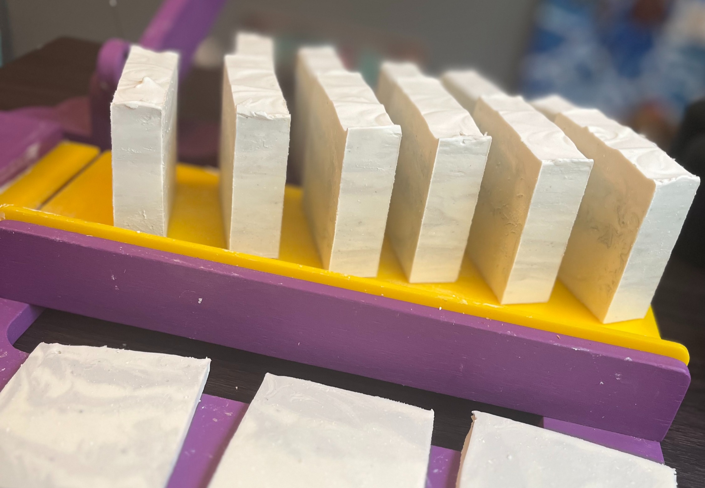 Gentle Woods soap bars displayed in a wooden curing tray