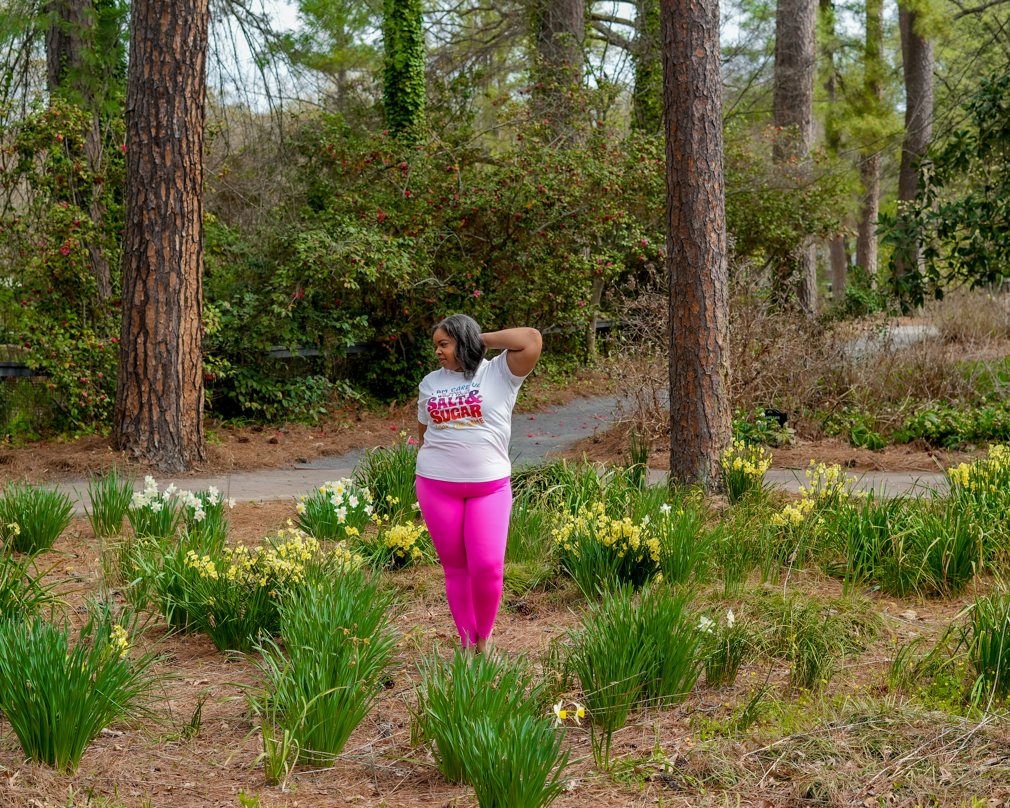 Natural XScentrics founder standing in a botanical garden setting